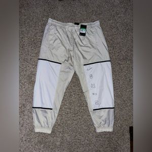 Cream and white Nike windbreaker pants
